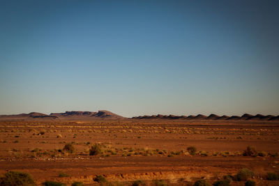 Scenic view of arid landscape against clear sky
