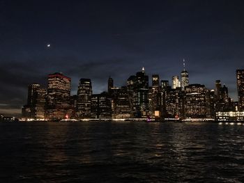 Illuminated city at waterfront