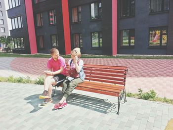 Full length of woman sitting on bench