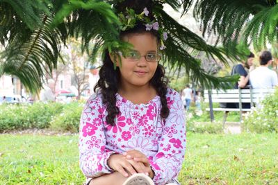 Portrait of girl sitting at park