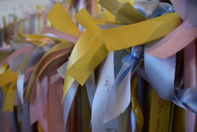 Close-up of yellow clothes hanging in store