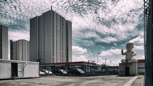 Buildings against cloudy sky