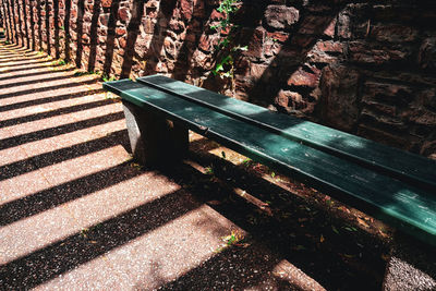 High angle view of bench by wall