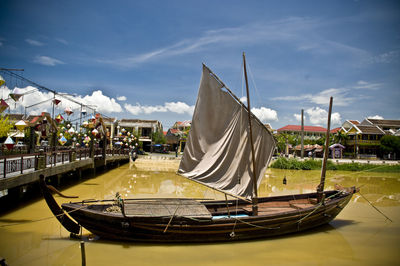 Boat in canal against sky