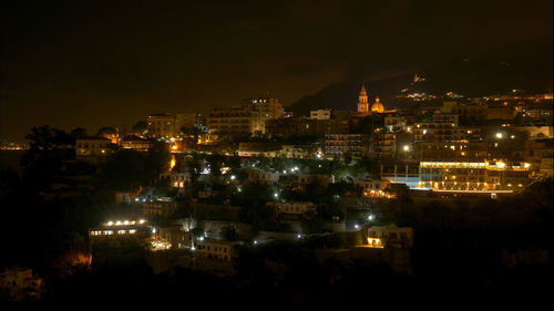 High angle view of illuminated buildings in city at night