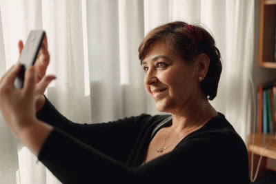 Portrait of woman using mobile phone