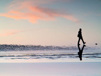 People on beach at sunset