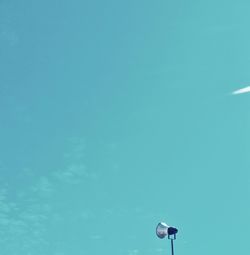 Low angle view of street light against blue sky