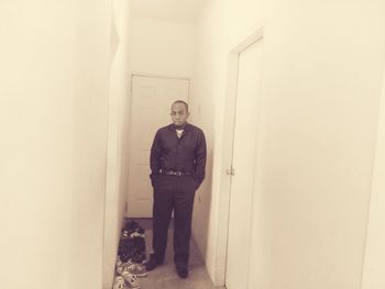 Portrait of man standing in corridor