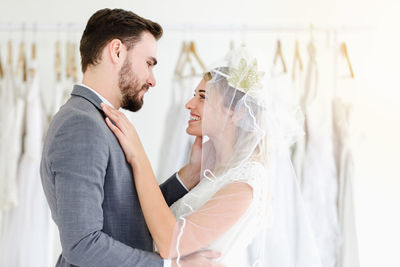 Side view of couple romancing while standing in store