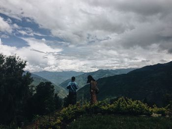 Scenic view of mountains against cloudy sky