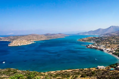 Scenic view of sea against clear blue sky