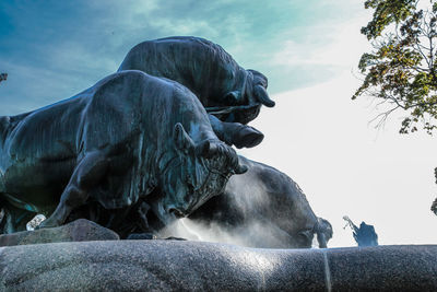 Low angle view of statue against rocks