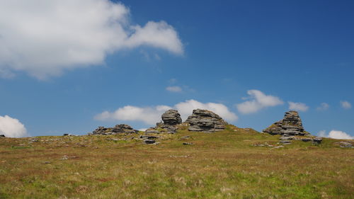 Panoramic view of rocks on field against sky