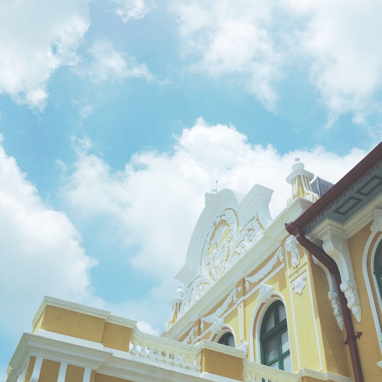 low angle view, architecture, built structure, building exterior, sky, religion, cloud - sky, place of worship, church, spirituality, cloud, high section, statue, history, sculpture, day, arch, human representation