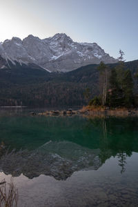 Scenic view of lake and mountains against sky