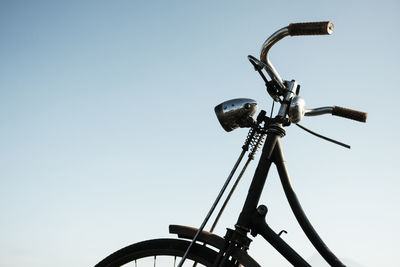 Low angle view of bicycle wheel against clear sky