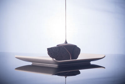 Close-up of cake on table against wall