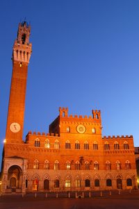 Low angle view of historical building against blue sky