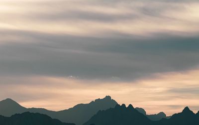 Scenic view of silhouette mountains against sky at sunset