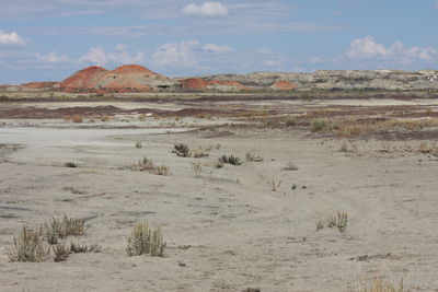 View of desert against cloudy sky