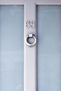 House number 68 on a light blue wooden front door in london 