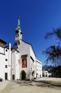 Low angle view of church against clear blue sky