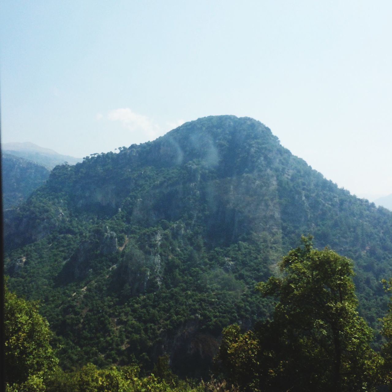 mountain, tranquil scene, tranquility, scenics, mountain range, beauty in nature, tree, nature, clear sky, landscape, non-urban scene, sky, growth, idyllic, low angle view, green color, lush foliage, remote, day, non urban scene