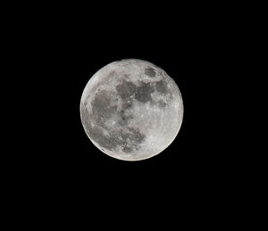 Low angle view of moon against black sky