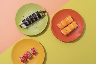 Directly above shot of food in plate on yellow background