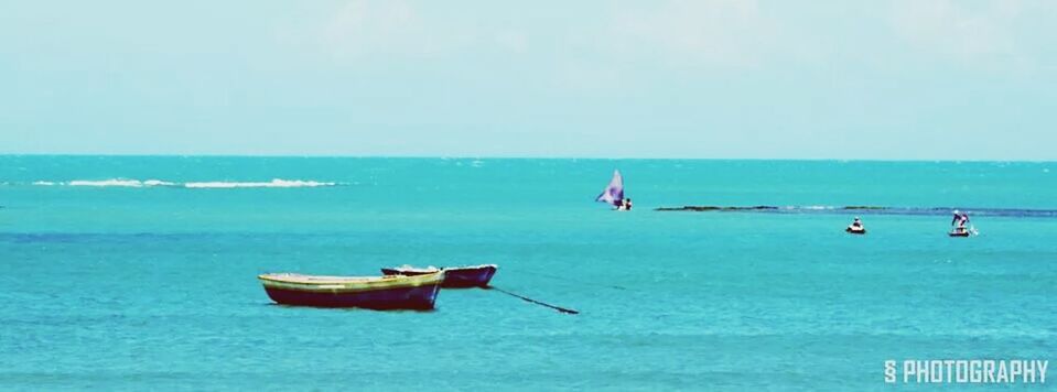 nautical vessel, transportation, sea, boat, mode of transport, water, horizon over water, blue, tranquility, moored, tranquil scene, nature, scenics, beauty in nature, travel, waterfront, copy space, clear sky, day, sky