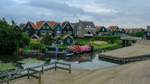 Plants by swimming pool by lake against buildings