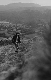 Rear view of woman walking on field