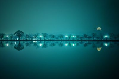 Scenic view of lake against sky at night