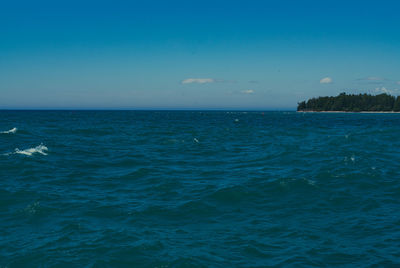 Scenic view of sea against blue sky