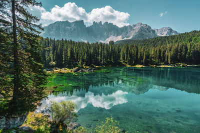 Lake carezza, view on the lake with the latemar range in the background. italy.