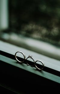 Close-up of wedding rings on window