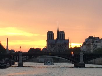 Bridge over river at sunset