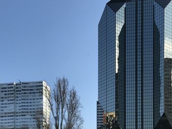 Low angle view of modern building against clear blue sky