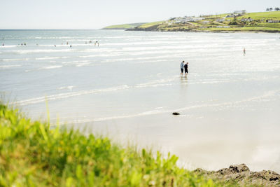 Rear view of man walking on beach