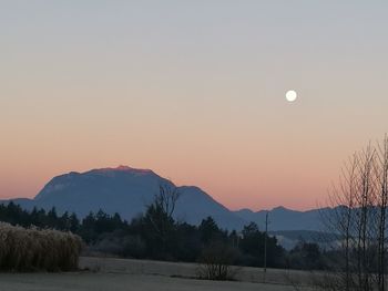 Scenic view of silhouette mountains against sky at sunset