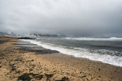 Scenic view of sea against cloudy sky