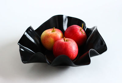 High angle view of apples in bowl against white background