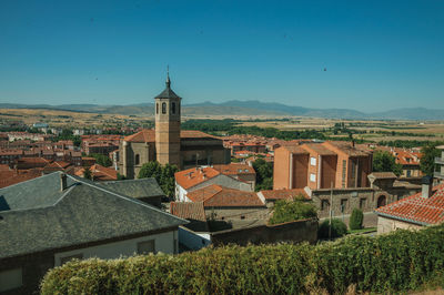 Houses in city against clear sky