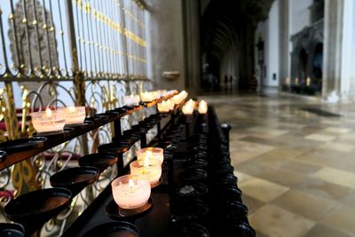 Lit tea light candles in church