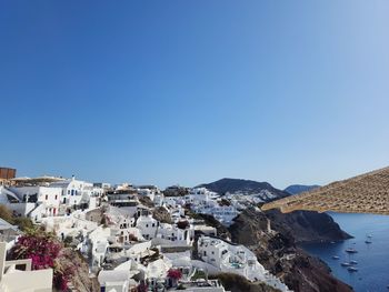 High angle view of townscape against clear blue sky