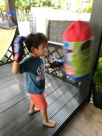 Boy playing with umbrella