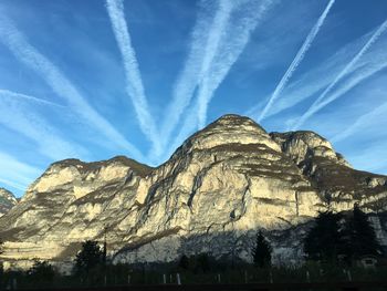 Low angle view of mountain range against blue sky