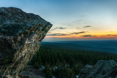 Scenic view of rock formation against sky during sunset