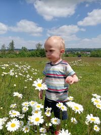 Cute boy standing on field